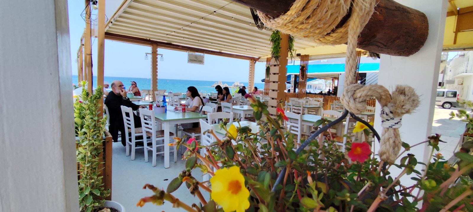 Taverna Maria beachfront terrace overlooking Haraki Bay and the Aegean Sea